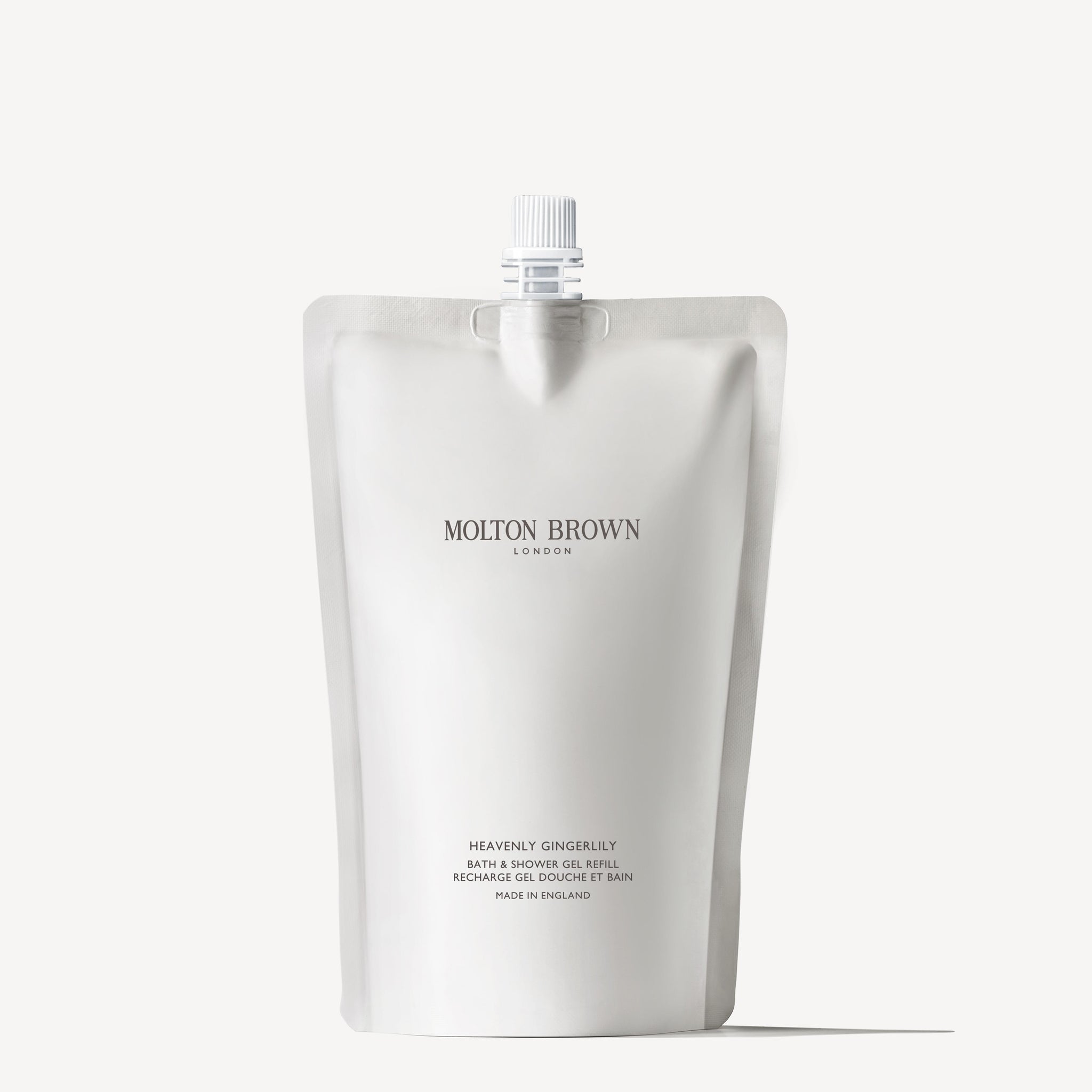 The 400ml Molton Brown Cyprus Heavenly Gingerlily Bath & Shower Gel Refill, featuring a top spout, is a sustainable choice. With its elegantly displayed logo and product info in sophisticated typography, its perfect for effortlessly maintaining your favorite body wash.