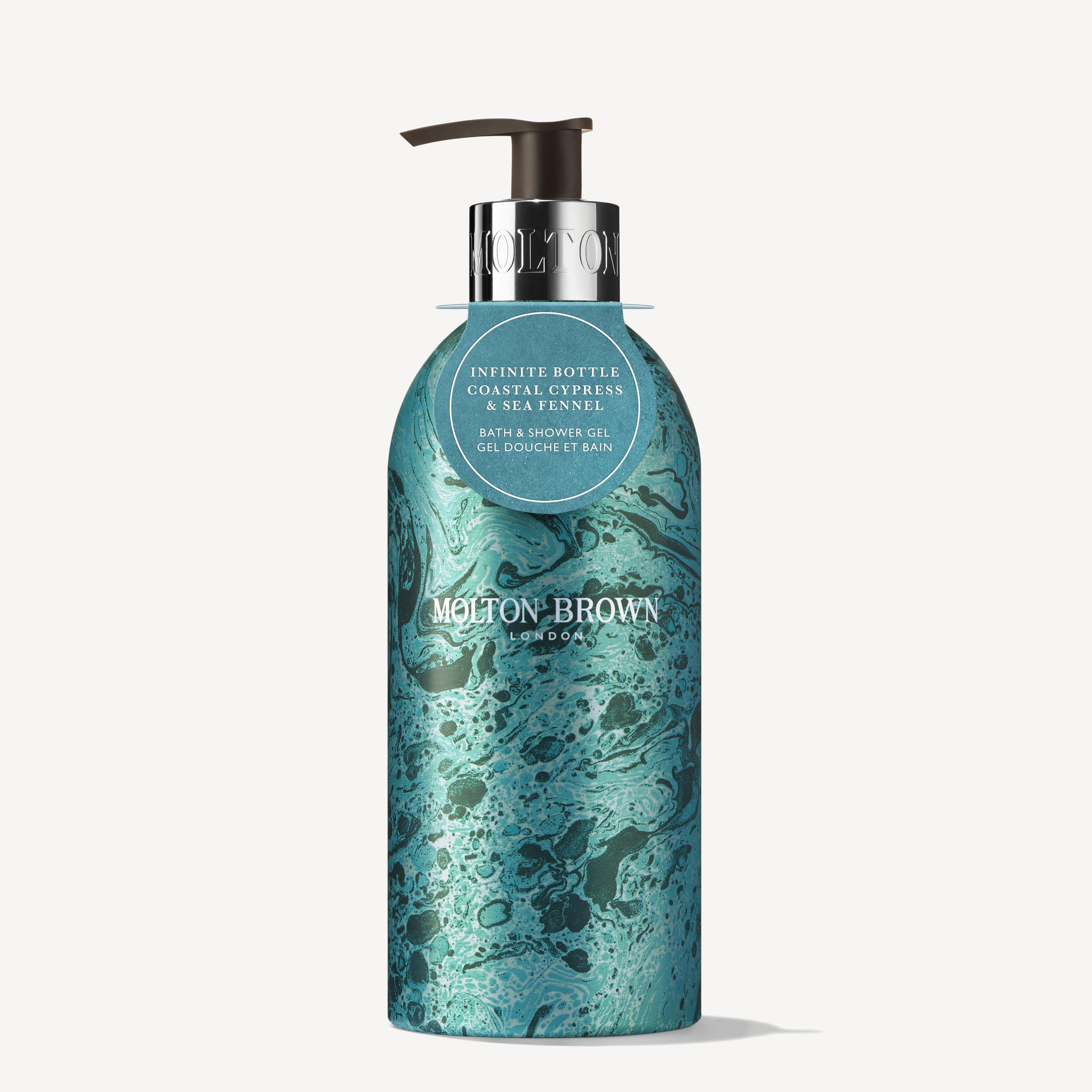 A teal bottle of MoltonBrown Cyprus Limited Edition Coastal Cypress & Sea Fennel Infinite Bottle bath and shower gel features a marbled design and a black pump top. This festive edition emphasizes its eco-friendly recycling information, providing an aromatic fragrance for an indulgent experience.