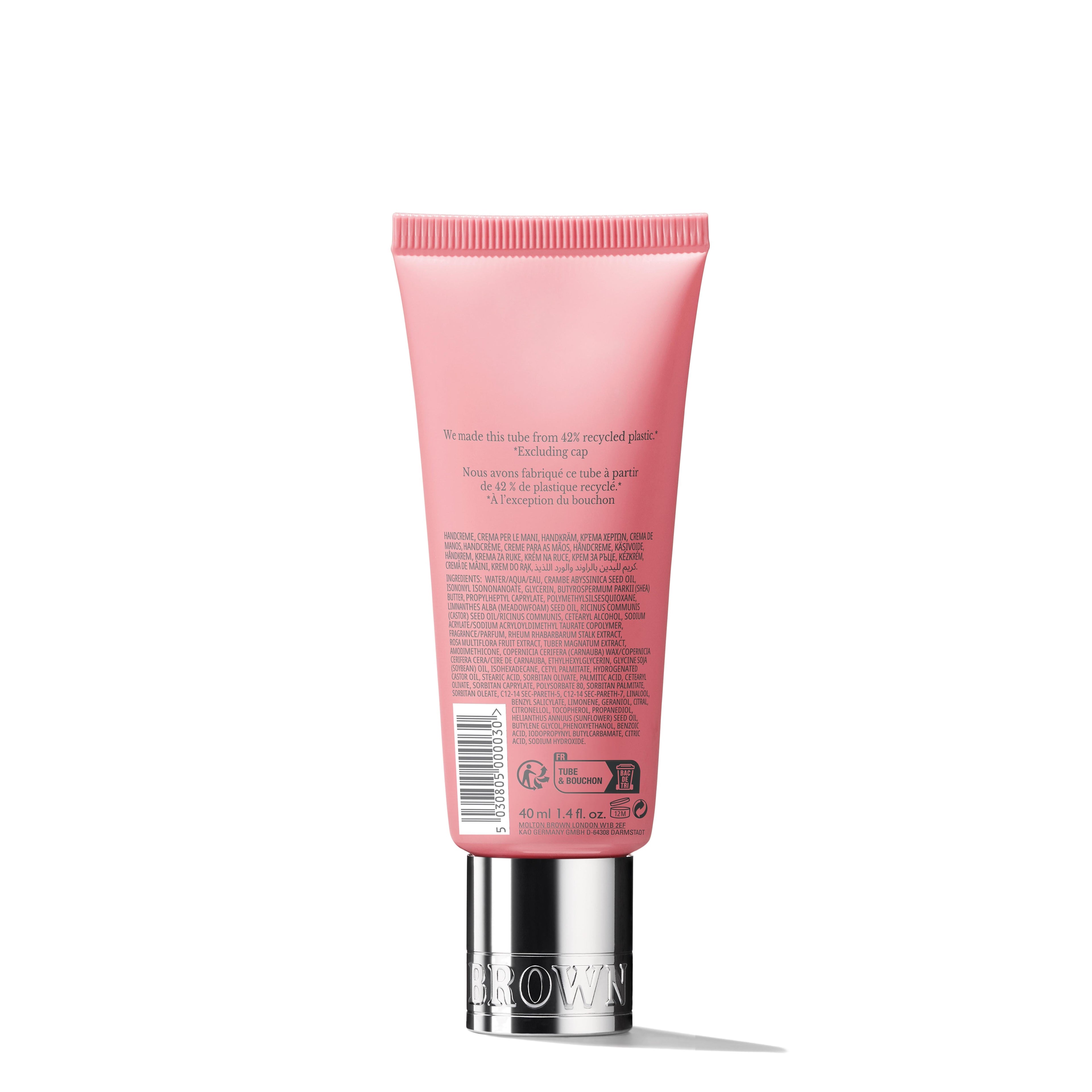 The MoltonBrown Cyprus Delicious Rhubarb & Rose Hand Cream 40ml stands upright against a plain white background in a pink tube with small font details, featuring the metallic cap at the bottom. Infused with vibrant rhubarb leaf for moisturizing benefits, it also highlights the use of recycled plastic.