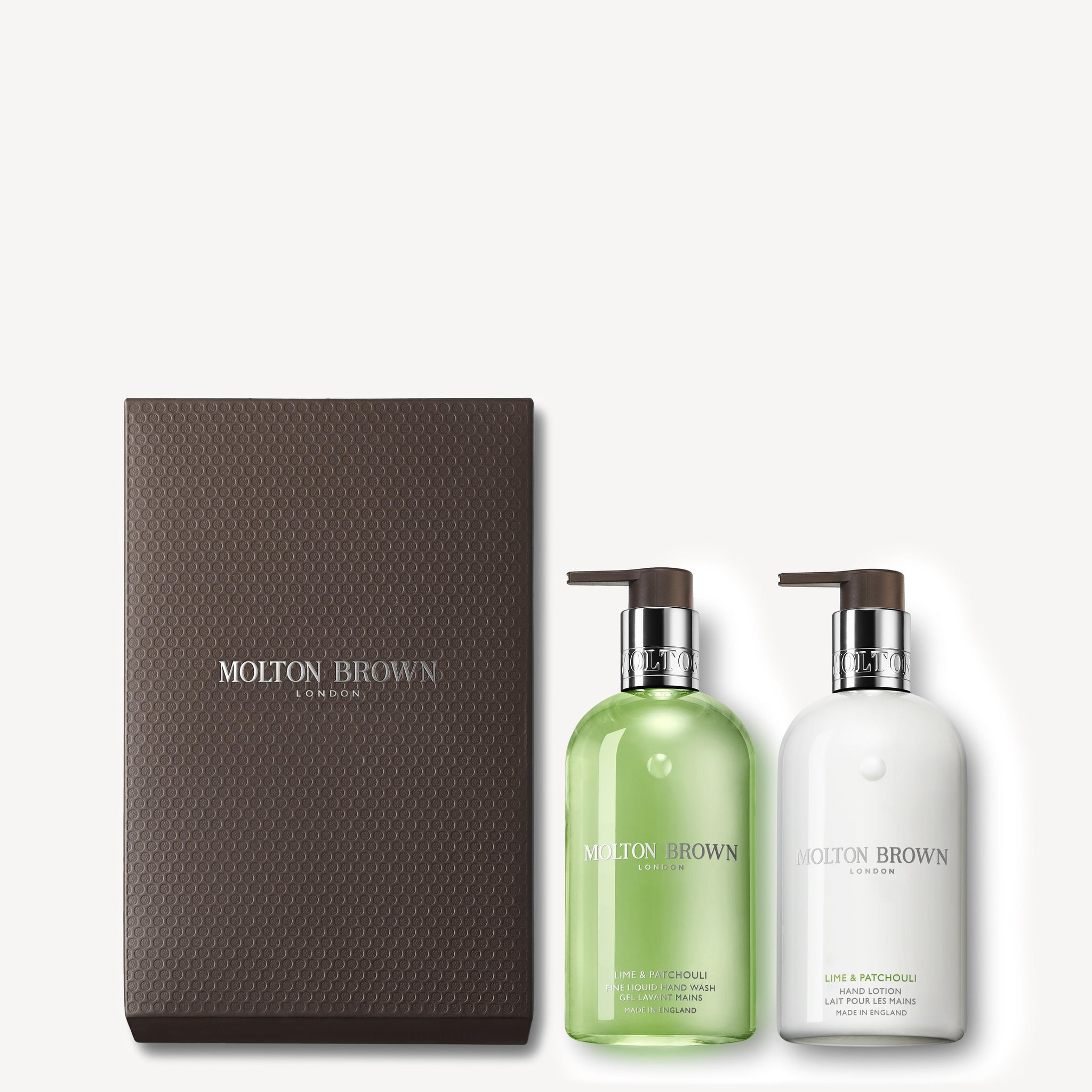 The Lime & Patchouli Hand Wash & Lotion Set by MoltonBrown Cyprus is presented in a dark textured box and includes a green bath and shower gel, as well as a white body lotion. Both items feature the invigorating essence of Thai lime leaves and are equipped with pump dispensers for ease of use.