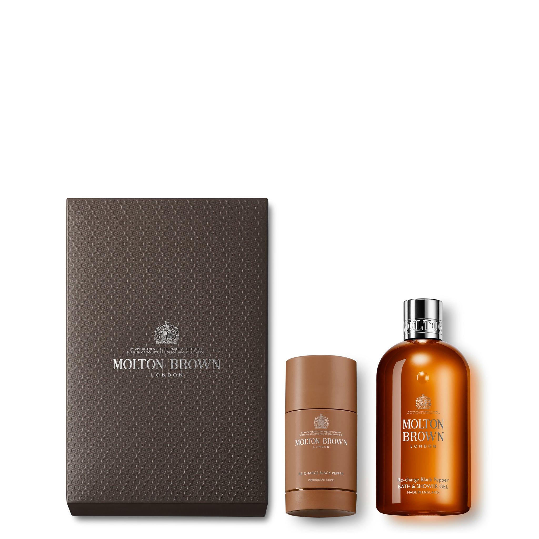 The MoltonBrown Cyprus Classic Re-charge Black Pepper Gift Set features a textured brown box containing a black pepper deodorant stick and an amber-colored body wash with silver accents. The elegant brand logo is prominently displayed on both the box and products.