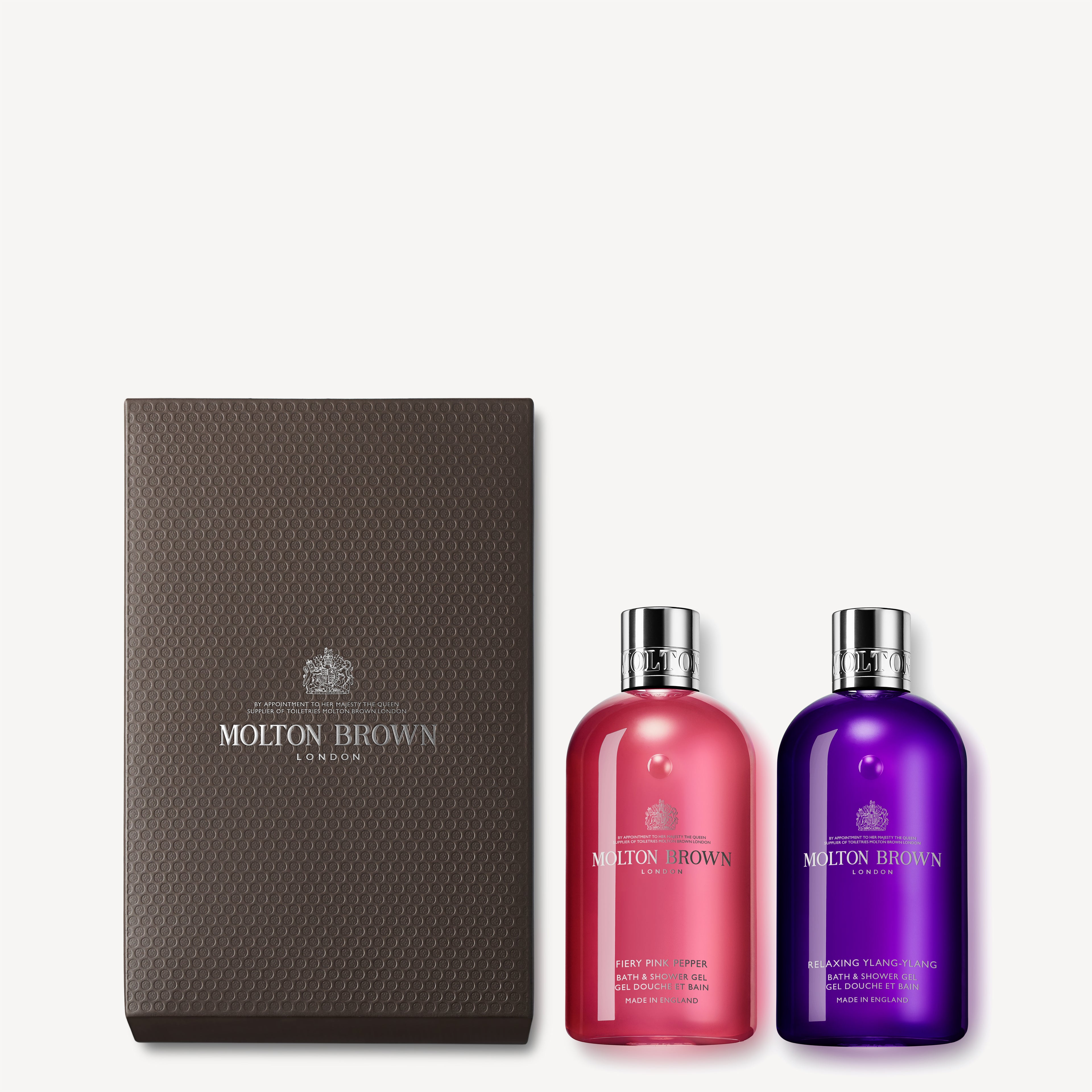 A luxurious gift box from MoltonBrown Cyprus contains the Fiery Pink Pepper & Ylang-Ylang Shower Gel Gift Set, elegantly displayed in vibrant pink and purple bottles.