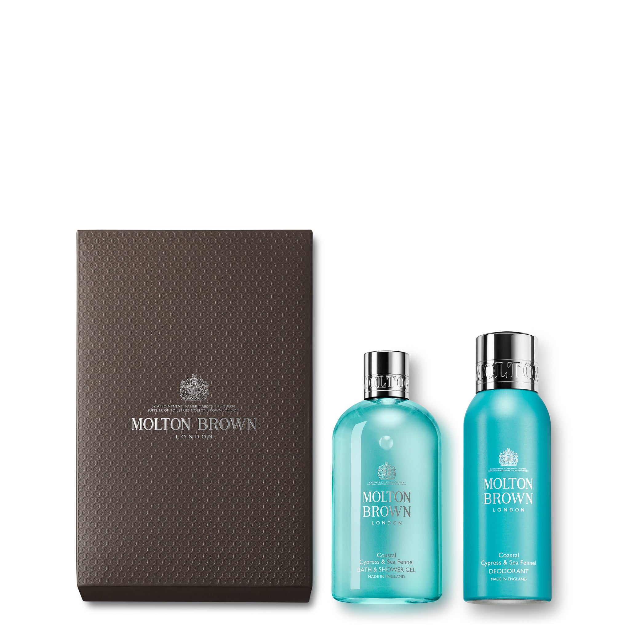 Introducing the Coastal Cypress & Sea Fennel Body Gift Set by MoltonBrown Cyprus, which comes in an elegant brown box and includes two turquoise bottles. Inside, you'll find a Coastal Cypress & Sea Fennel Bath & Shower Gel and a matching Body Lotion. Both bottles are topped with silver caps and prominently feature the brand's logo.